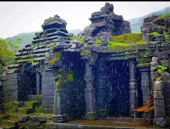 Ancient temple stone structure under heavy monsoon rain